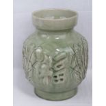 A heavy green glazed Oriental pottery va