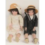 A pair of contemporary porcelain dolls e