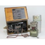 A British WWII field telephone in case together with a field portable stove. Two items.