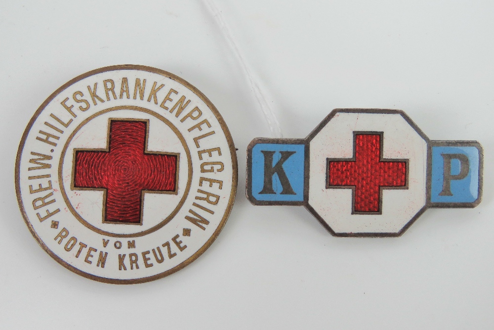 A WWII Austrian Red Cross badge 'freiw hilfs kranken pflegerin' being red enamel on a white ground