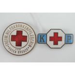 A WWII Austrian Red Cross badge 'freiw hilfs kranken pflegerin' being red enamel on a white ground