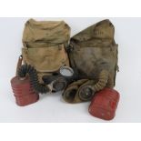 Two WWII British Military issue satchel gas masks, both with filters and kit.