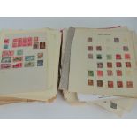Stamps; a large quantity of assorted world stamps stuck down on loose pages.