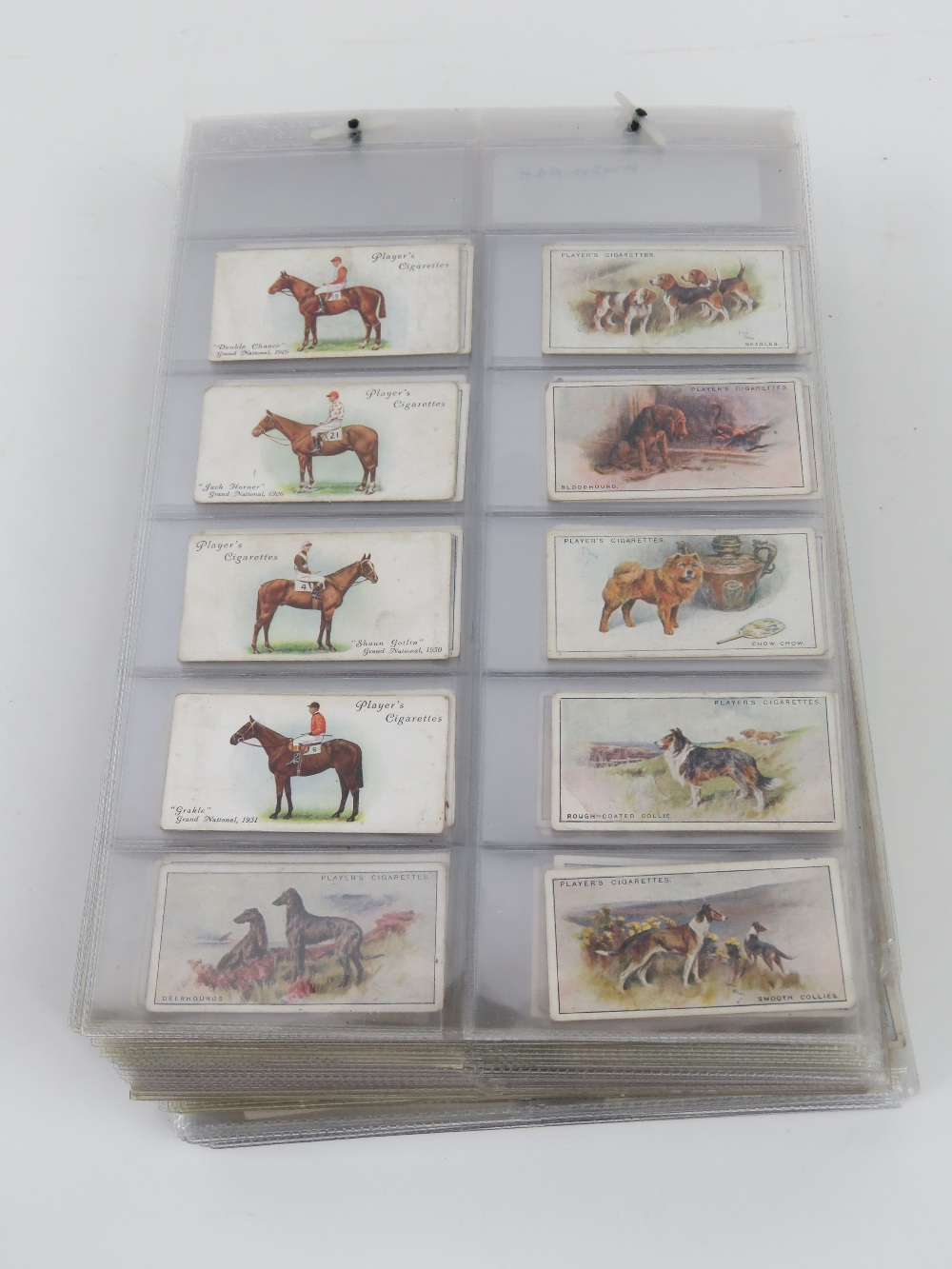 A collection of John Player & Sons cigarette cards sorted into sets/part sets in binder pages,