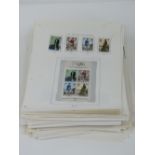 Stamps; a large quantity of assorted Elizabeth II Great Britain stamps stuck down on loose pages.