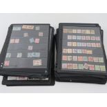 A large quantity of stamps in loose leaf binder pages, approximately 150 pages unbound.