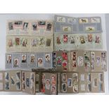 A quantity of Wills cigarette card booklets including; our king and queen, wild flowers, dogs,