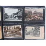 An album of assorted early 20th century vintage postcards including; topographical, trains,