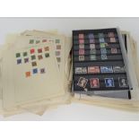 Stamps; a large quantity of assorted world stamps stuck down on loose pages.