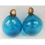 Two decorative blown blue and amber glass baubles.