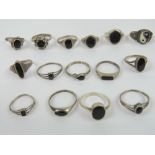 Nine silver and onyx rings together with five black enamel and silver rings and a silver Ying Yang