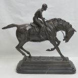 A heavy bronze figurine of a horse and jockey,