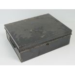 A large vintage black painted metal cash box, complete with end handles, with key slightly a/f,