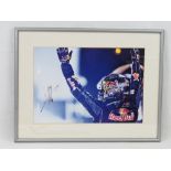 A signed framed print of Sebastian Vettel winning for Red Bull Racing, 28 x 40cm.