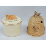 A Crown Devon Guernsey butter dish and cover, together with a 'beehive' honey pot and cover.