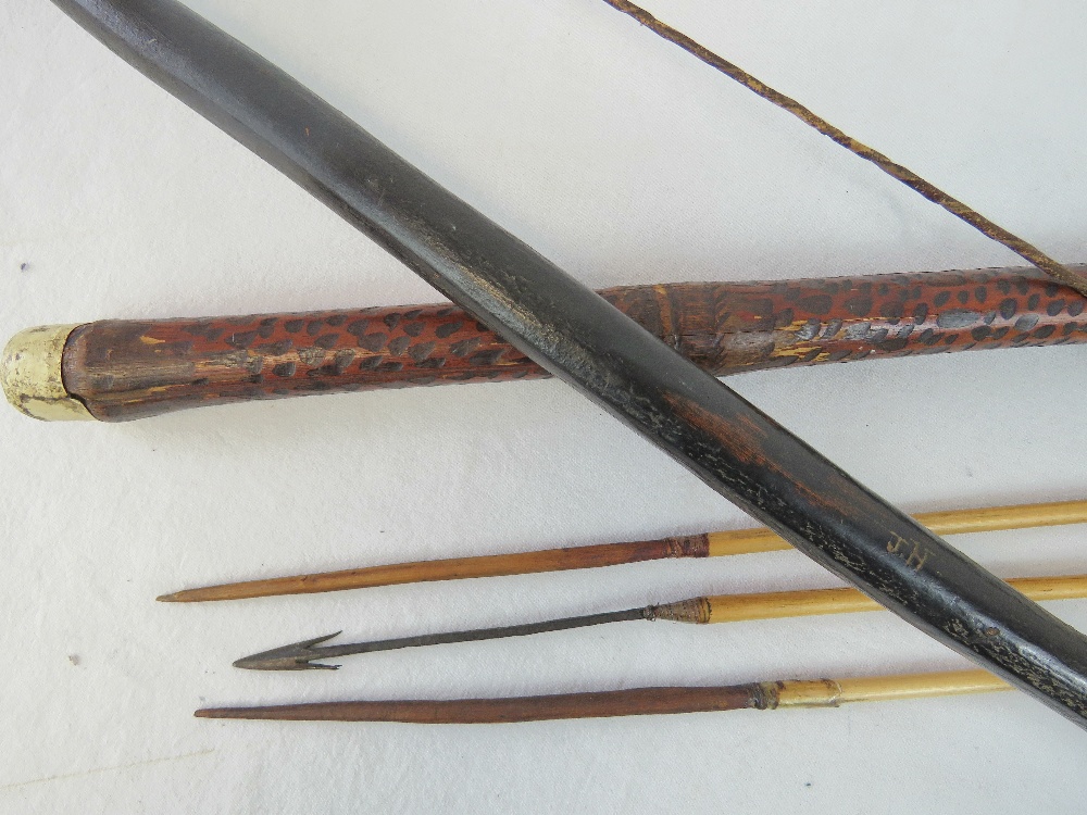 An ethnic tribal wood self bow with gut string and carved nocks, - Image 2 of 2
