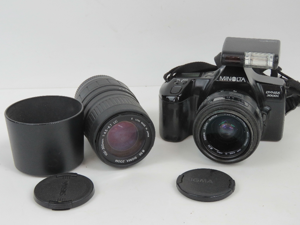 A Minolta Dinax 3000i 35mm SLR camera with a sigma 100-300mm zoom lens.