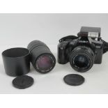 A Minolta Dinax 3000i 35mm SLR camera with a sigma 100-300mm zoom lens.