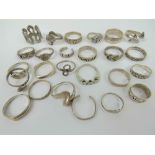 Twenty-six assorted silver rings including hallmarked silver signet ring, 925 silver dolphin ring,