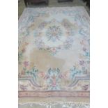 An Oriental woollen and silk carpet in cream ground with foliate decoration,