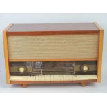A good walnut cased tabletop radio as made by Ferrit, ivorex buttons and knobs, measuring 68cm wide.