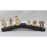 A set of six carved Woolley Mammoth tusk figurines in the Oriental style bring a five-piece band