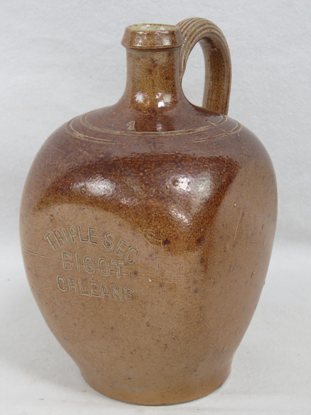 A square shaped stoneware triplesec Bigot Orleans jug, 17cm high.