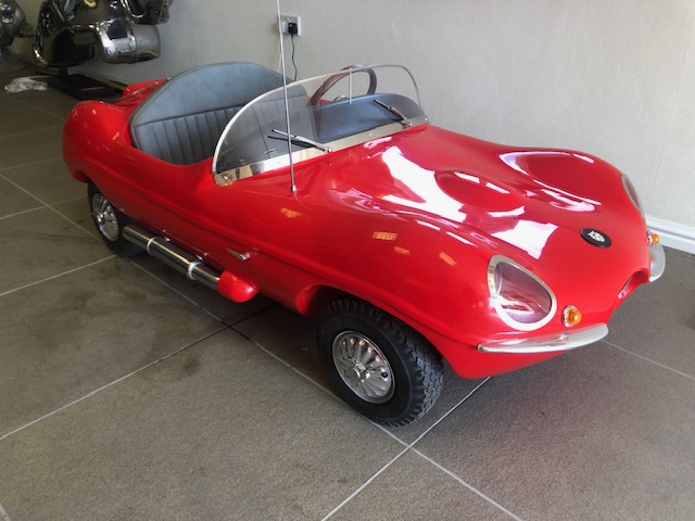 A Watsonian XK SS Jaguar scale model child's car C 1959 with BSA single cylinder petrol engine.