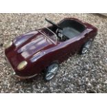 A Sanko E-Tupe Jaguar pedal car C1960s. Finely detailed metal body measuring 105cm in length.