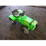 A John Deere pedal tractor C1980s. Plastic body 75cm in length.