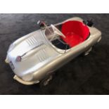 A Tri-ang E-Type Jaguar pedal car C1960s. Finely detailed metal body measuring 108cm in length.