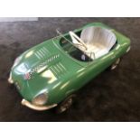 A Tri-ang E-Type Jaguar pedal car C1960s. Finely detailed metal body measuring 110cm in length.