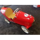 A Tri-ang pedal car C1960s. Finely detailed metal body measuring 74cm in length.