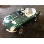 A Tri-ang E-Type Jaguar pedal car C1960s. Finely detailed metal body measuring 108cm in length.