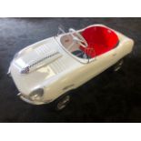 A Tri-ang E-Type Jaguar pedal car C1960s. Finely detailed metal body measuring 108cm in length.