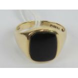 A 9ct gold signet ring having central rectangular uncarved onyx cabachon, hallmarked London, size O,