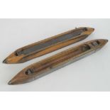 A pair of 19th century sprung beechwood loom shuttles, each measuring 53cm in length.