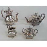 A large and ornate silver plated tea set by S.