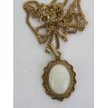 A 9ct gold pendant having large central opal cabachon (approx 13 x 10mm), hallmarked 375,