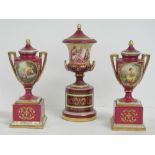 A single hand painted and gilded lidded urn on stand in pink ground, 24cm high.