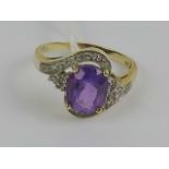 A 9ct gold Amethyst ring, the large central oval cut amethyst approx 2.11ct (approx 9.8 x 7.8 x 5.