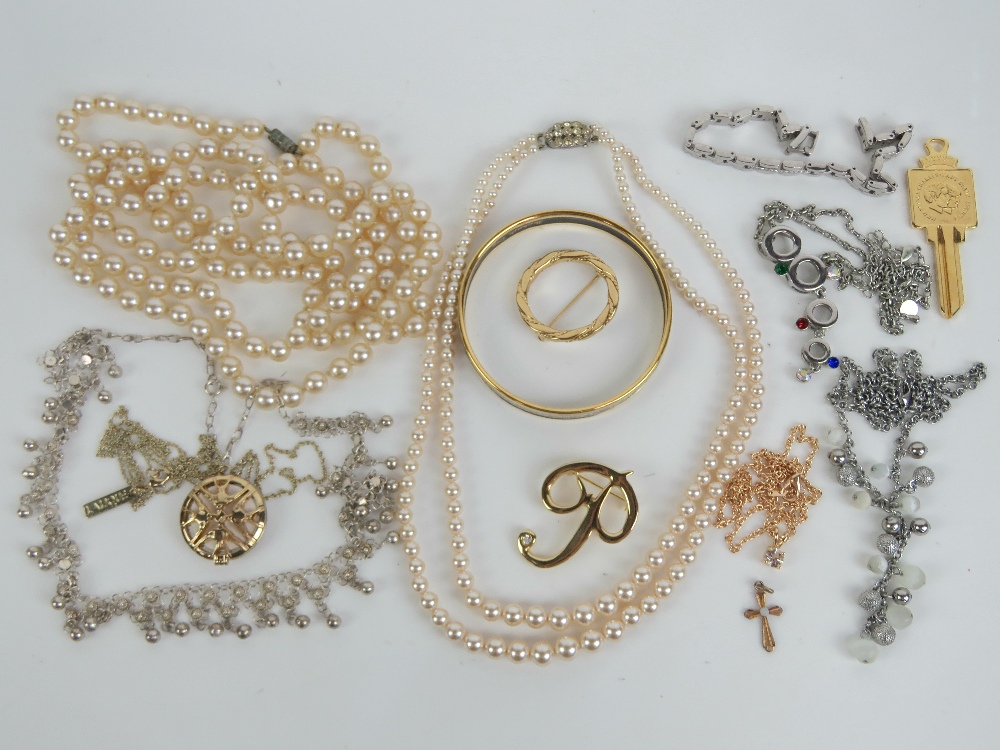 A quantity of costume jewellery including faux pearls, enamelled bangle,