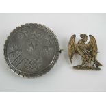 A white metal circular Victorian mourning brooch having lock of hair verso,
