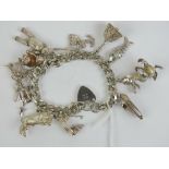 A HM silver charm bracelet having heart padlock clasp hallmarked for Birmingham,