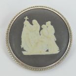 A Wedgwood black Jasperware brooch having silver frame, 4cm dia.