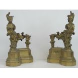A substantial pair of cast brass fire dogs each surmounted by the form of a fine 18th century lady
