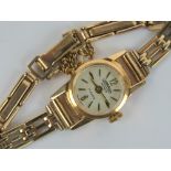 An 18ct gold Cornavin ladies wristwatch having 9ct gold strap,