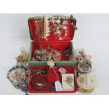 A quantity of costume jewellery within dressing table jewellery box, includes brooches, bracelets,