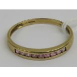 A 9ct gold half eternity ring set with pale pink stones, hallmarked 375, size W, 2g.