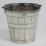 A silver plated ice bucket with swing handle marked Carrington Regent Street under, 19cm high.